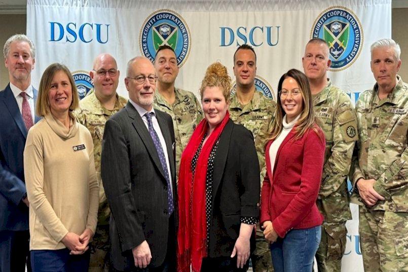 image of soldiers and civilians standing in front of DSCU sign