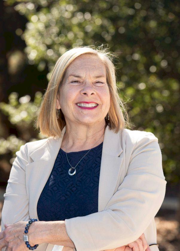 a picture of a woman in a beige blazer