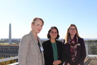 picture of a group of women standing on top of a building