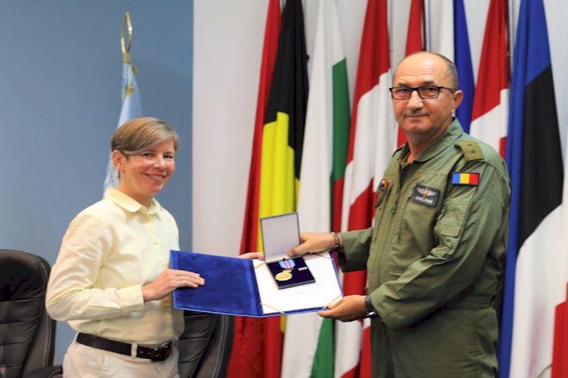 Ms. Lynn Sylmar accepting Romanian Air Force Emblem of Honor.